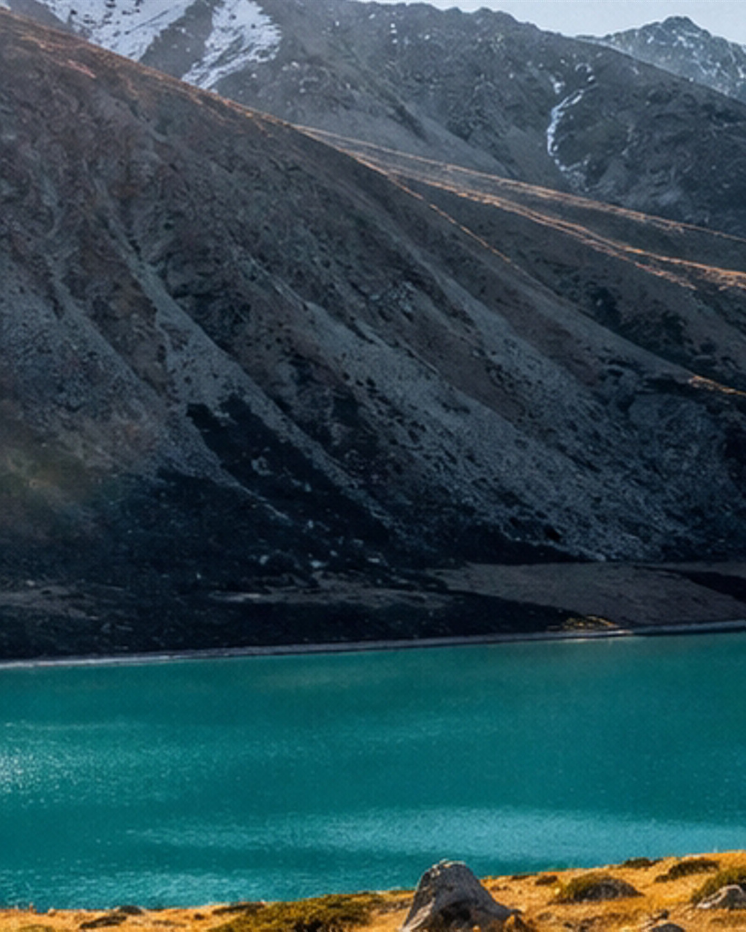 Carousel slide 1, dark slope and turquoise lake